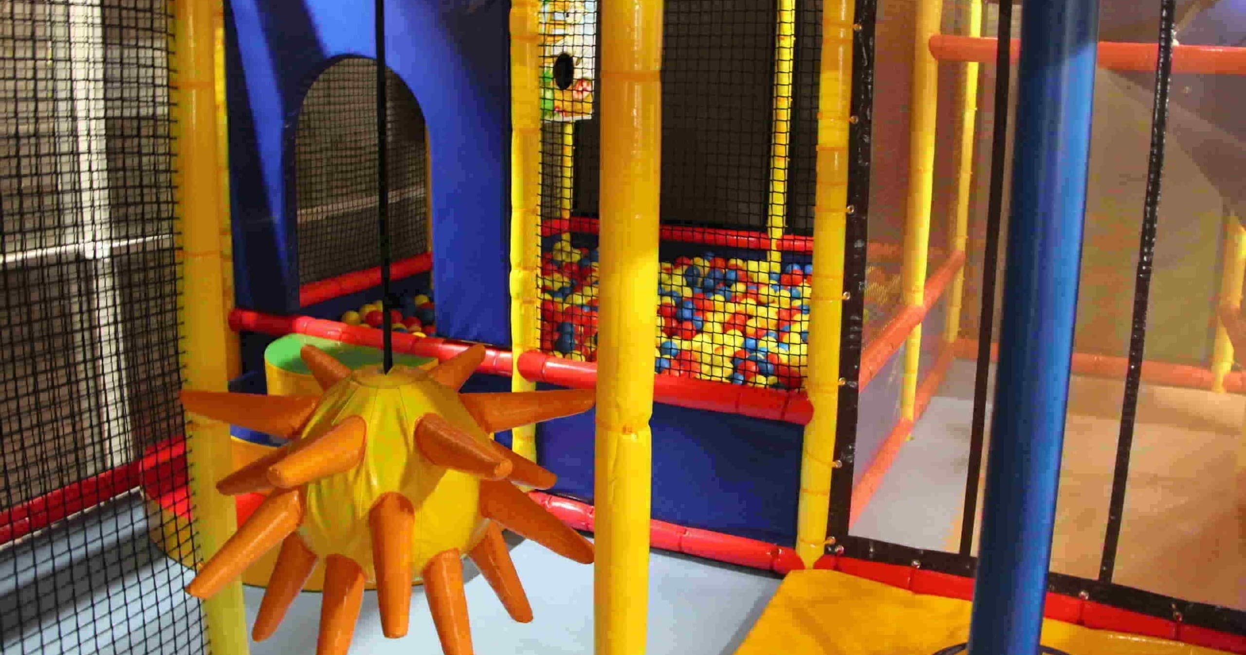 Soft play ball pit and foam obstacles inside indoor play maze