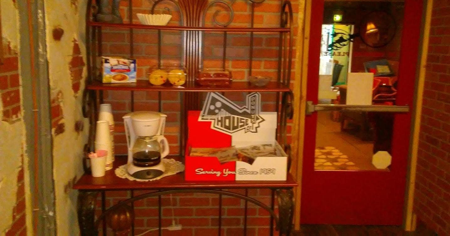 Cozy café interior with coffee station and rustic shelving, indoor scene