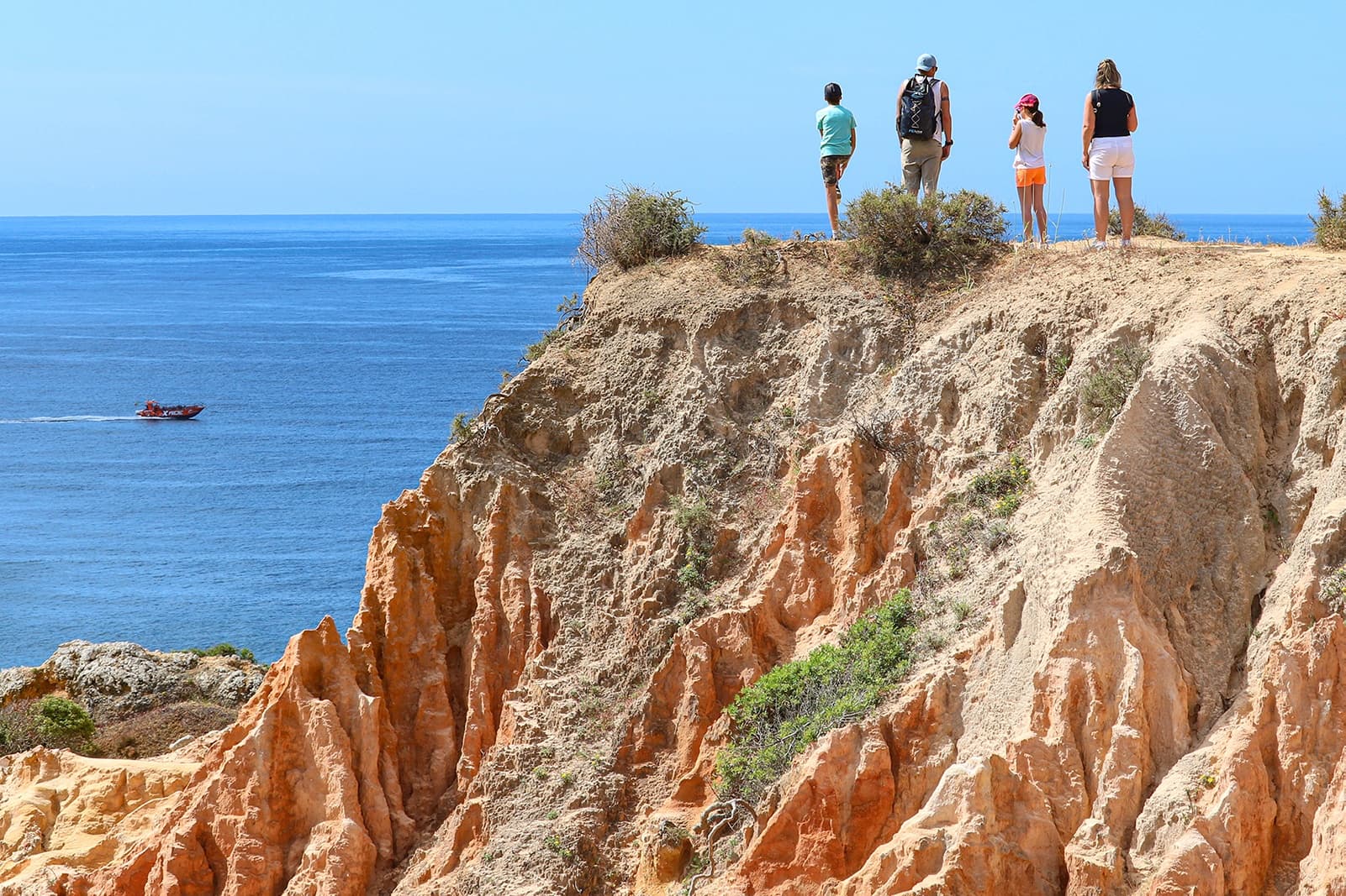 Cliffside coastal hike overlooking ocean cliffs with hikers