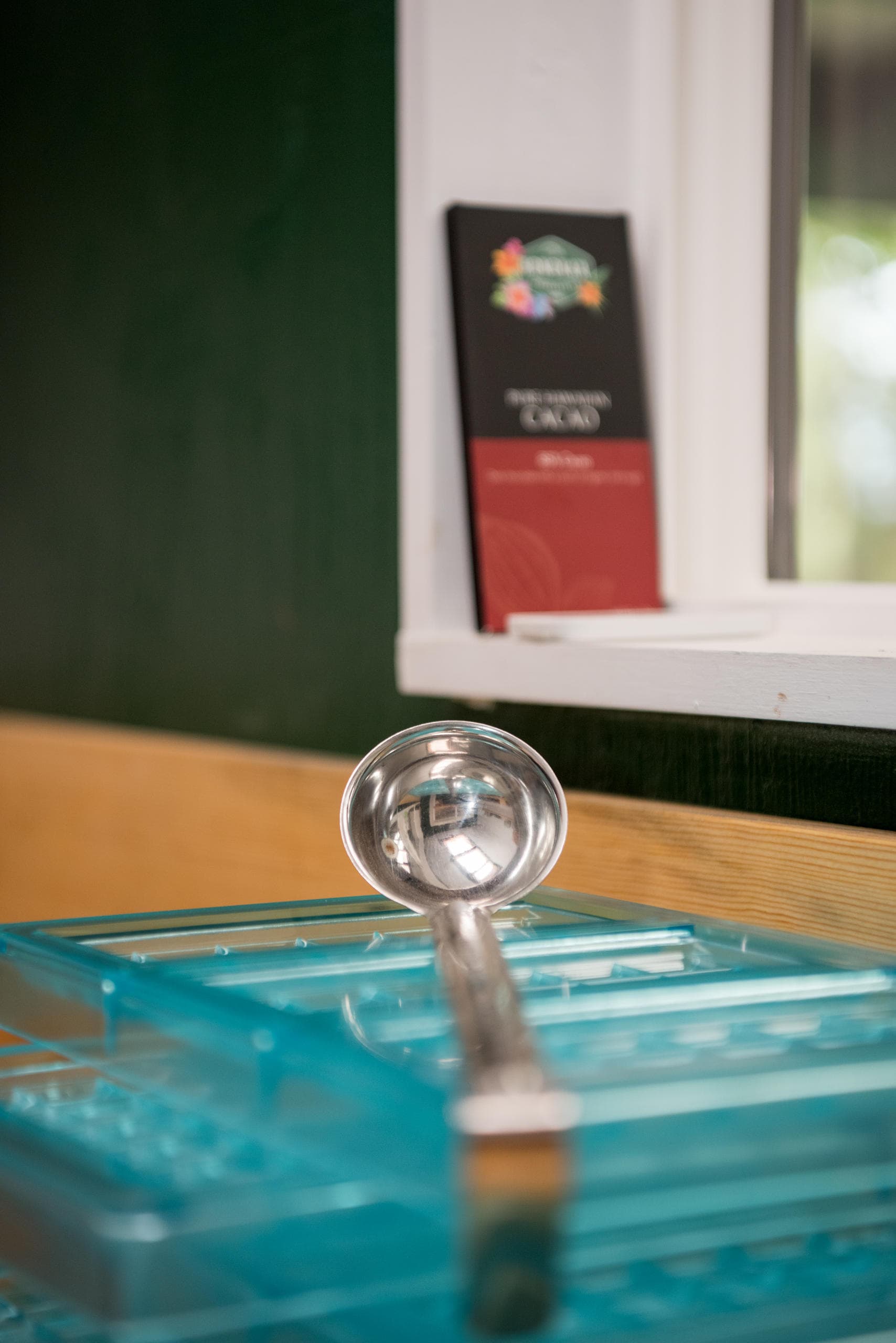 Pouring melted chocolate into molds at bean-to-bar workshop