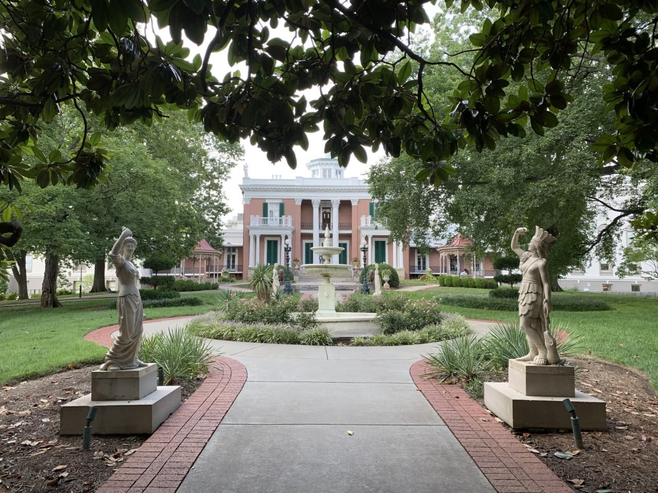 Pathway with statues leading to Belmont Mansion, landscaped grounds