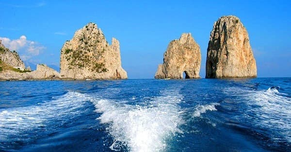 Boat wake passing Capri sea stacks off Amalfi Coast, Italy
