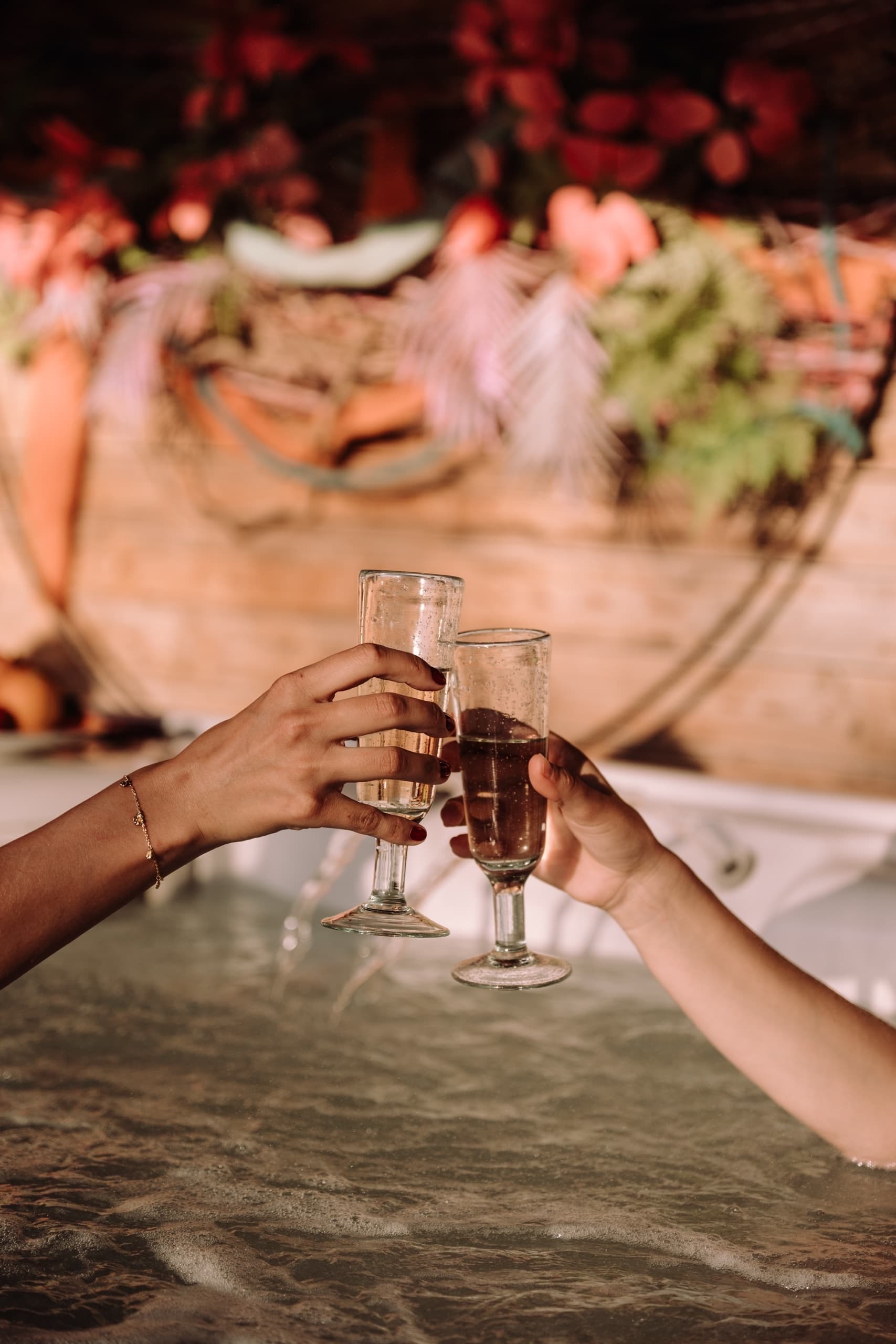Friends toasting with glasses while relaxing in a hot tub