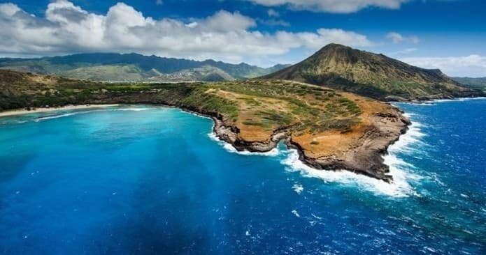 Aerial panoramic view of turquoise coastline and dramatic cliffs