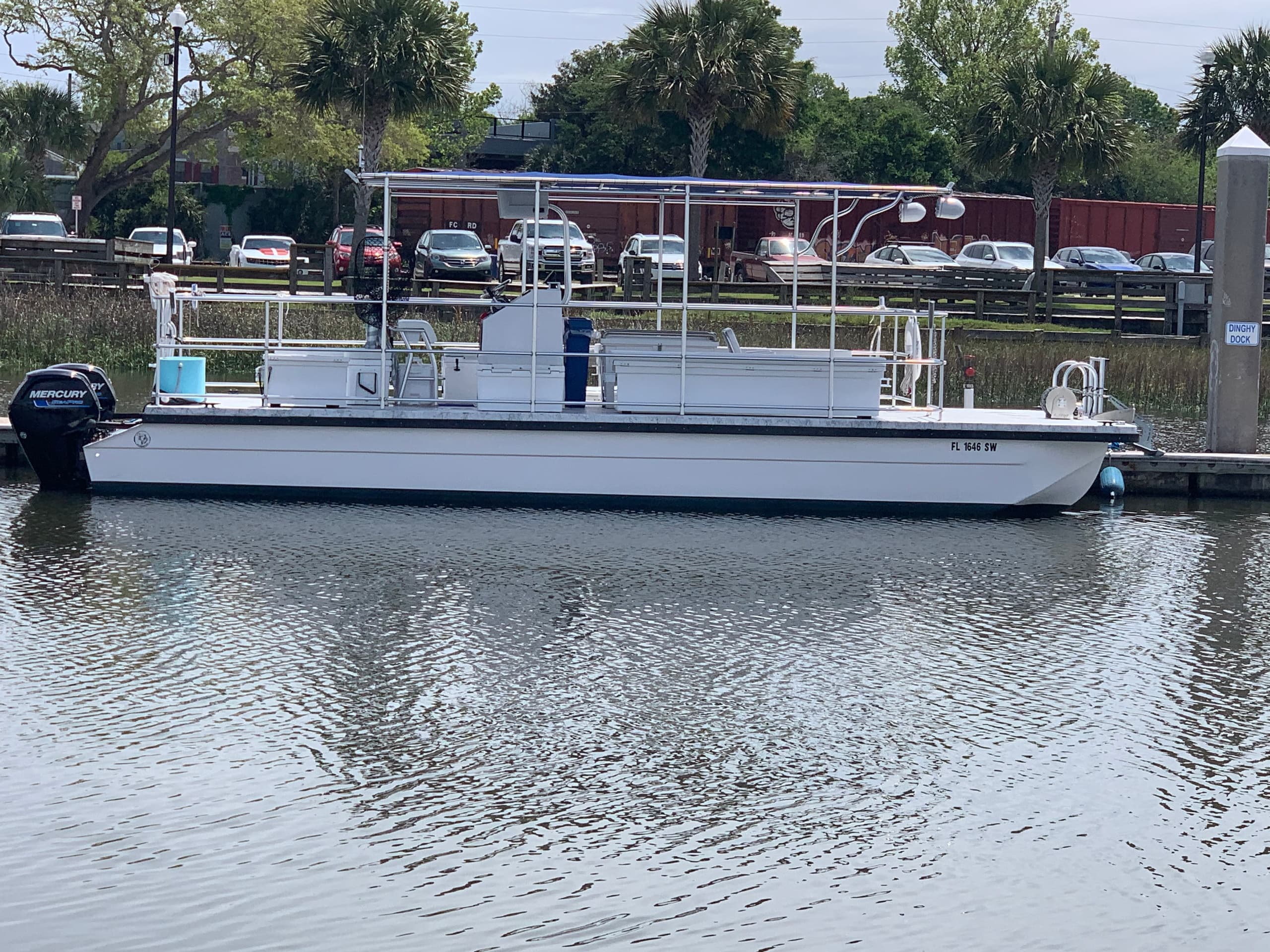 Parked charter pontoon boat at Amelia Island marina waterfront