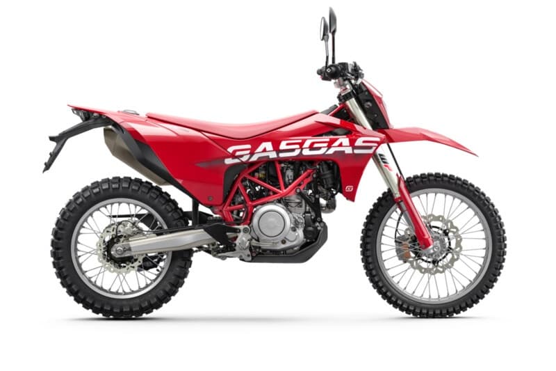 Red off-road dirt bike on white studio background, adventure ready