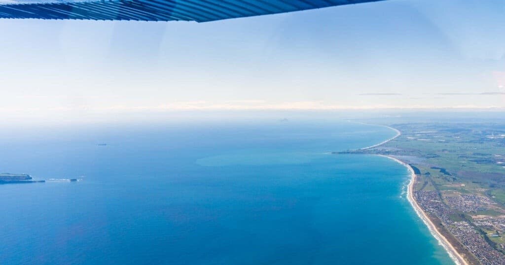Coastal aerial shot from small plane showing Tauranga shoreline