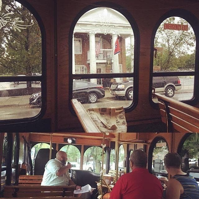 Interior trolley view through arched windows overlooking street and mansion