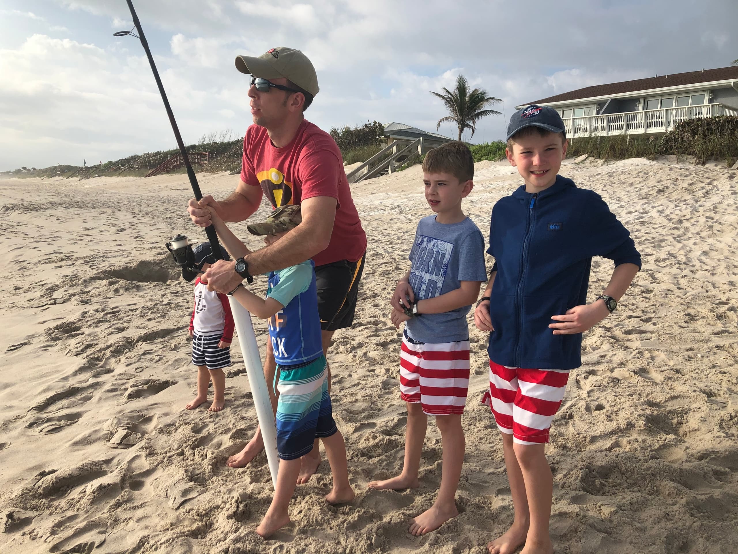 Anglers surf fishing from sandy shoreline at Cocoa Beach, Florida