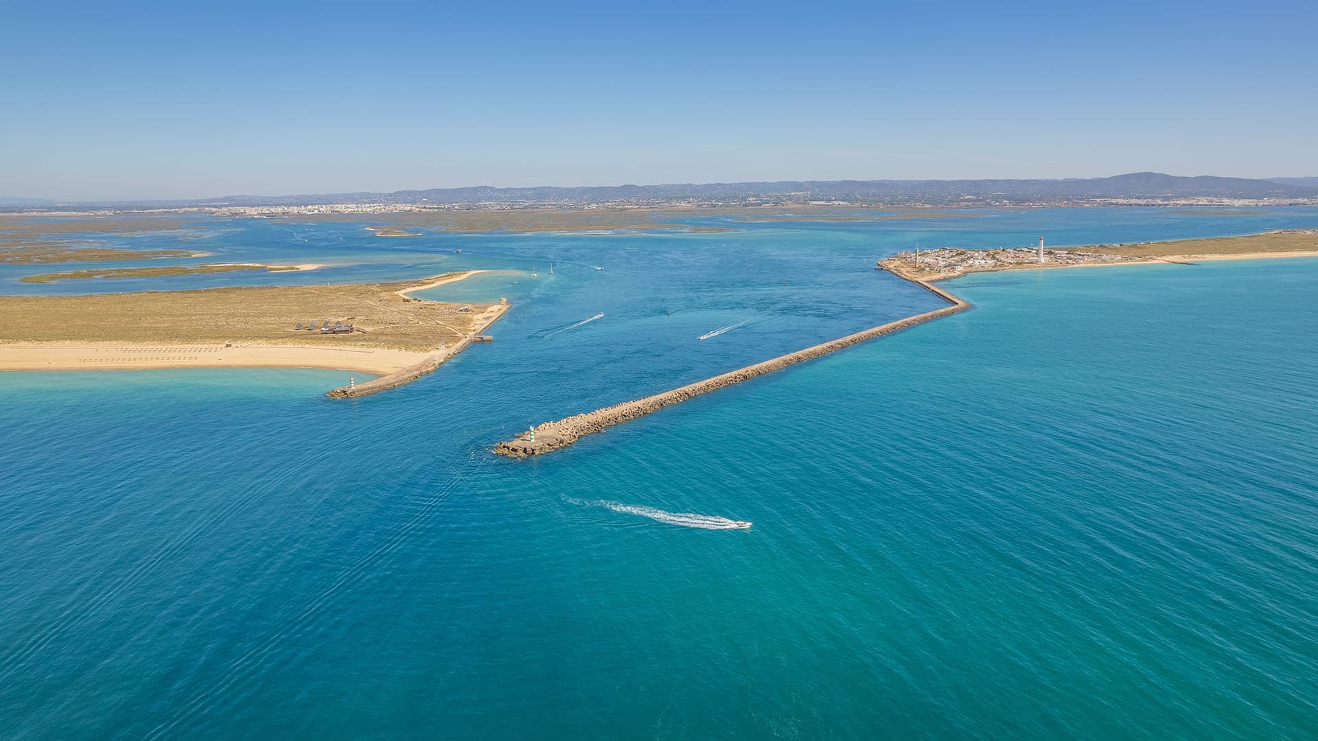Aerial view of sandbank and boats in clear turquoise sea