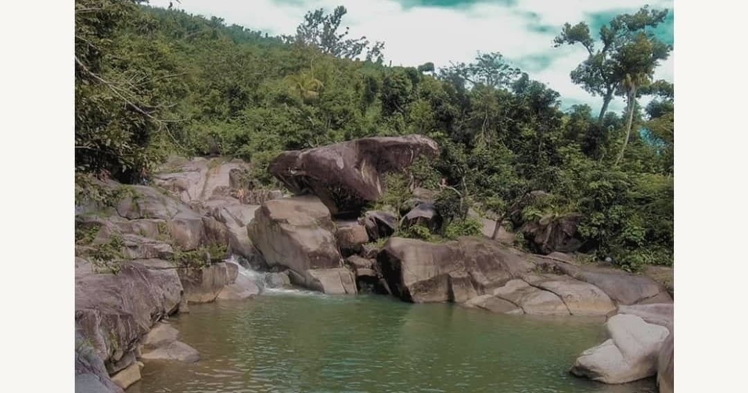 Rocky freshwater pool and boulder scramble in tropical forest