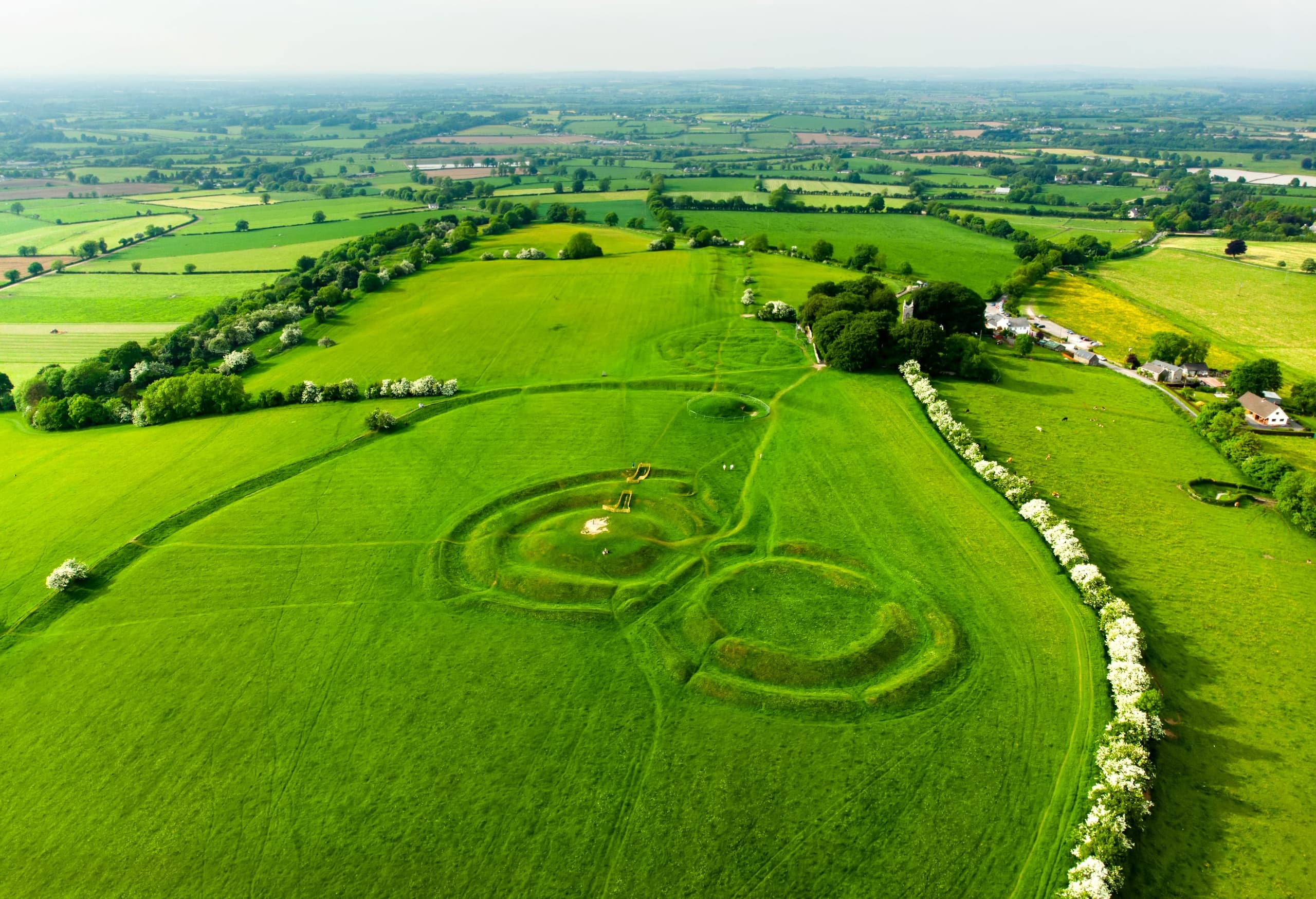 Aerial crop circle spirals on lush green farmland near Newgrange