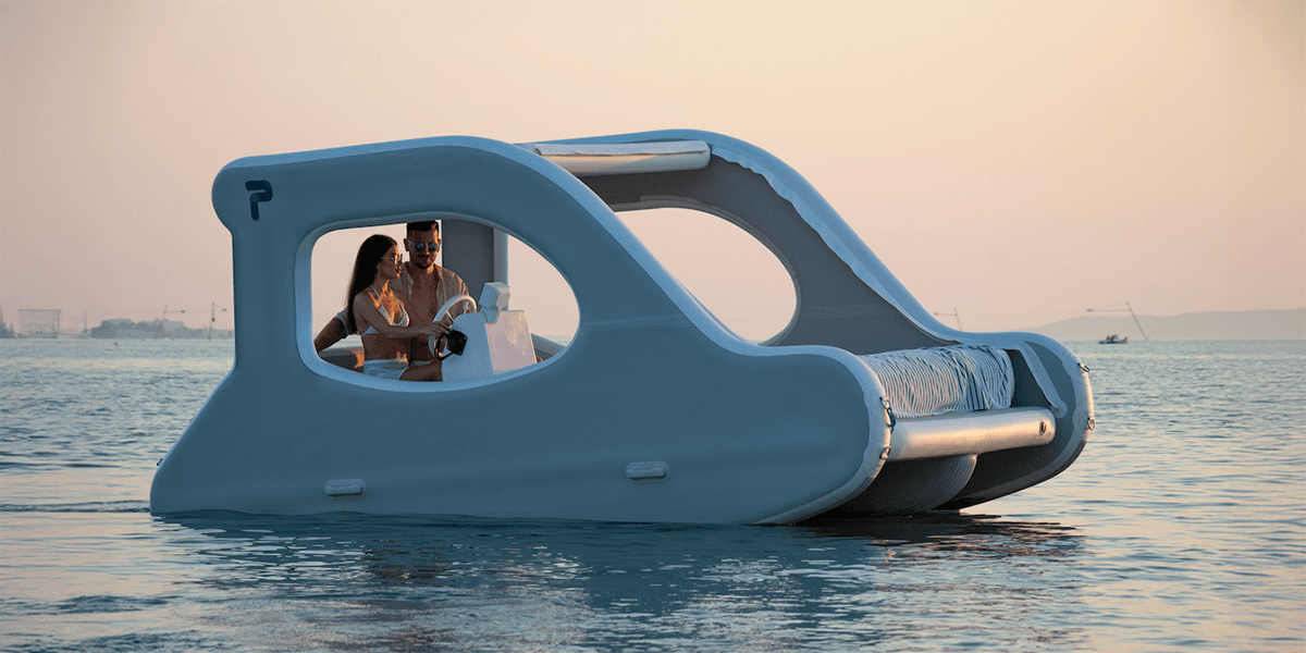 Couple relaxing on modern pedal boat at calm sea sunset