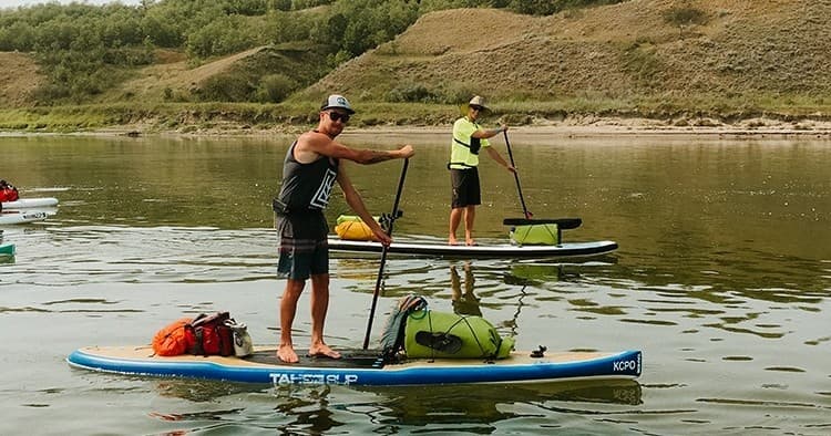 Fully loaded expedition SUPs on river, multi-day touring