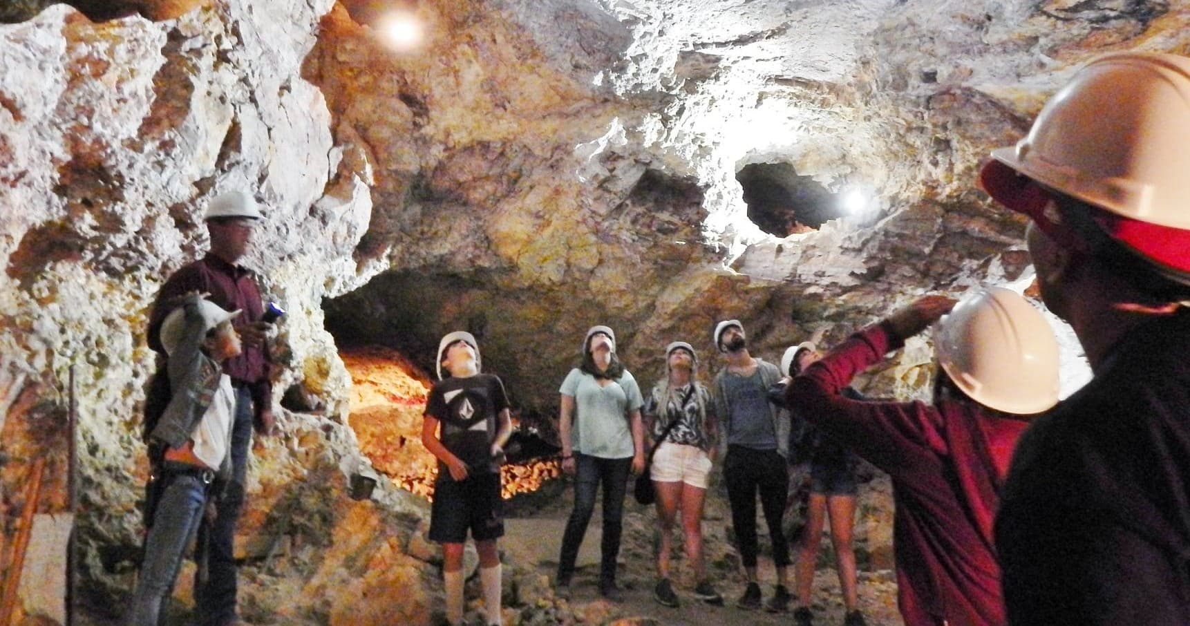 Guided underground silver mine tour in rocky cavern setting