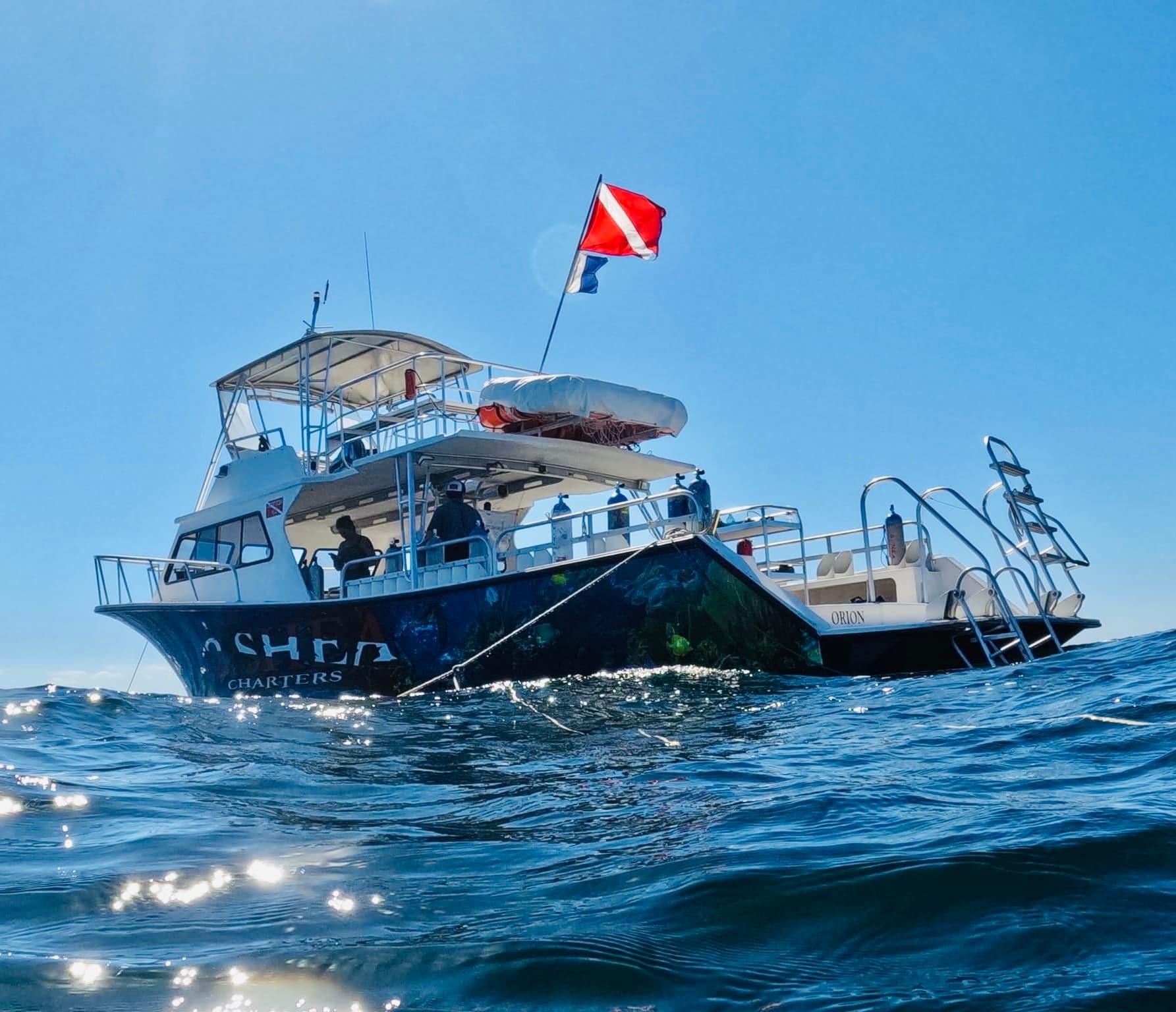 Charter dive boat at sea with dive flag cruising offshore