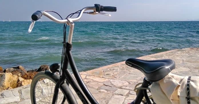 Coastal bike parked by sea shore with ocean horizon view