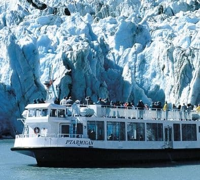 Glacier cruise boat viewing towering Portage Glacier ice cliffs