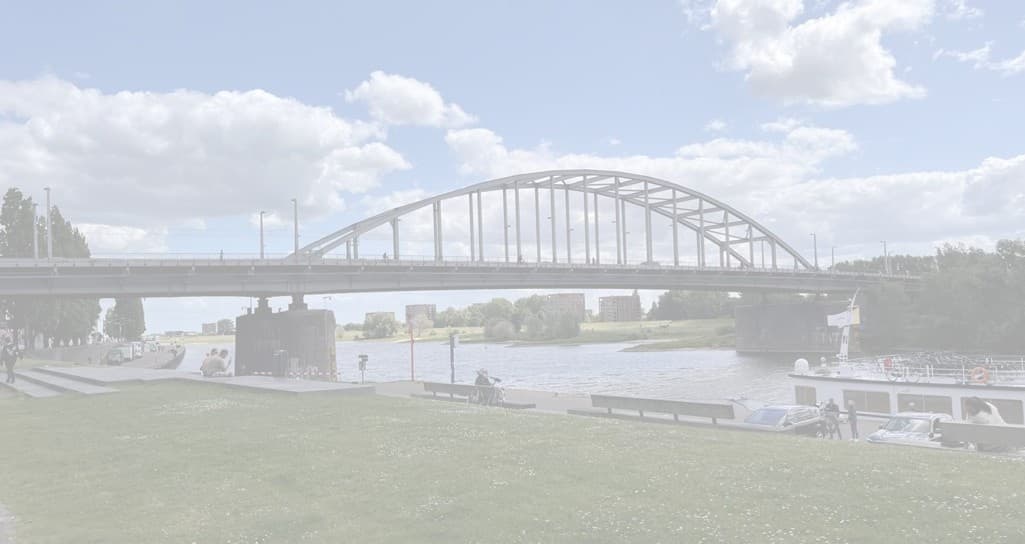 River bridge spanning water with grassy riverbank, scenic stroll