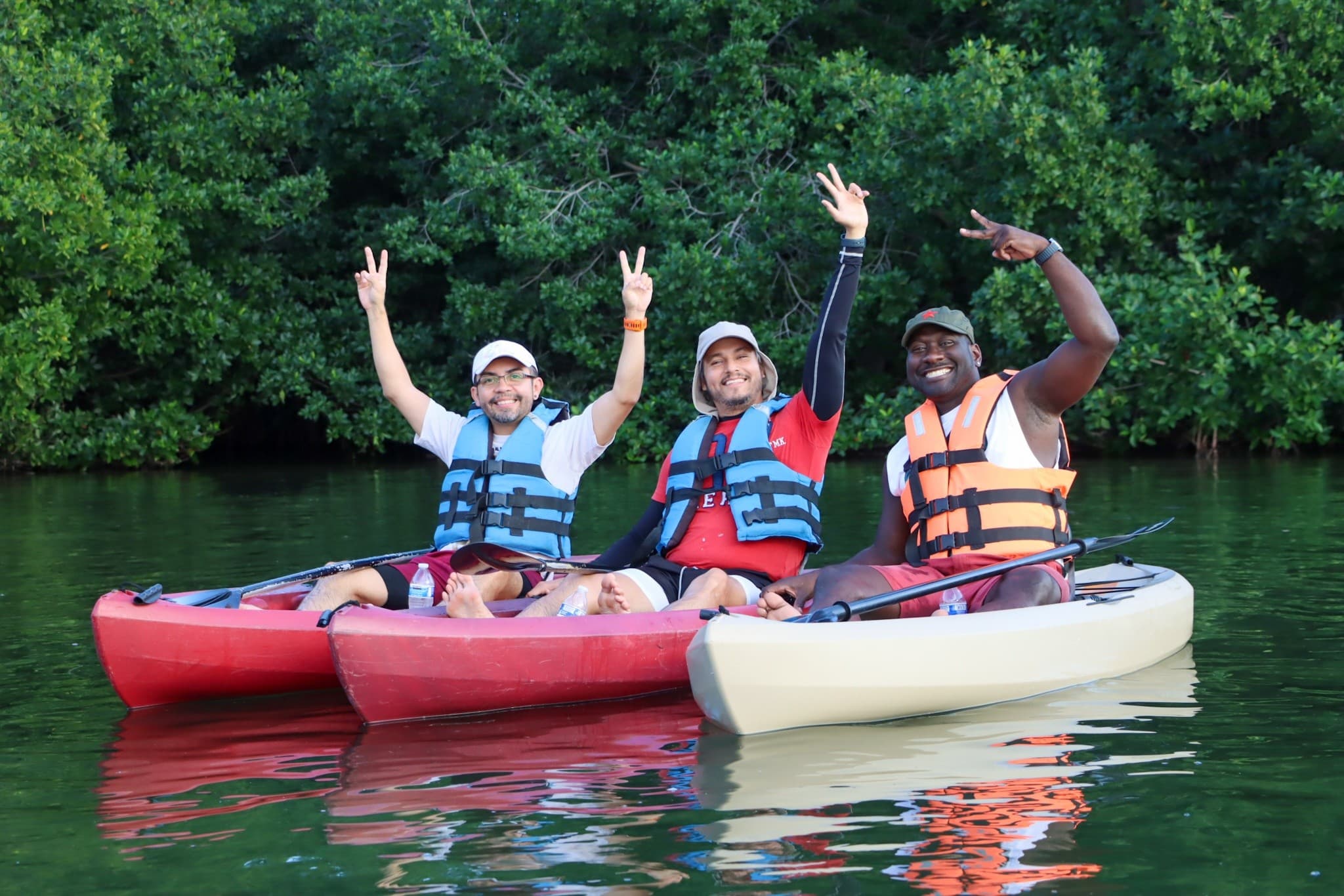 Kayakers enjoying calm sunrise paddle through mangrove estuary