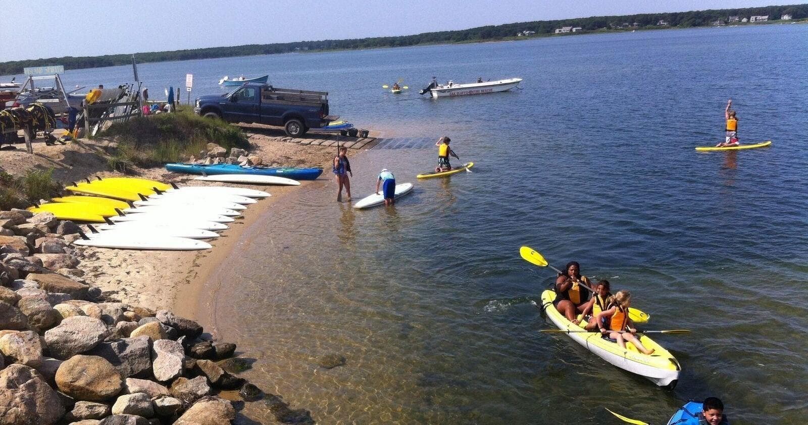 Dragon boat paddlers racing in shallow coastal bay