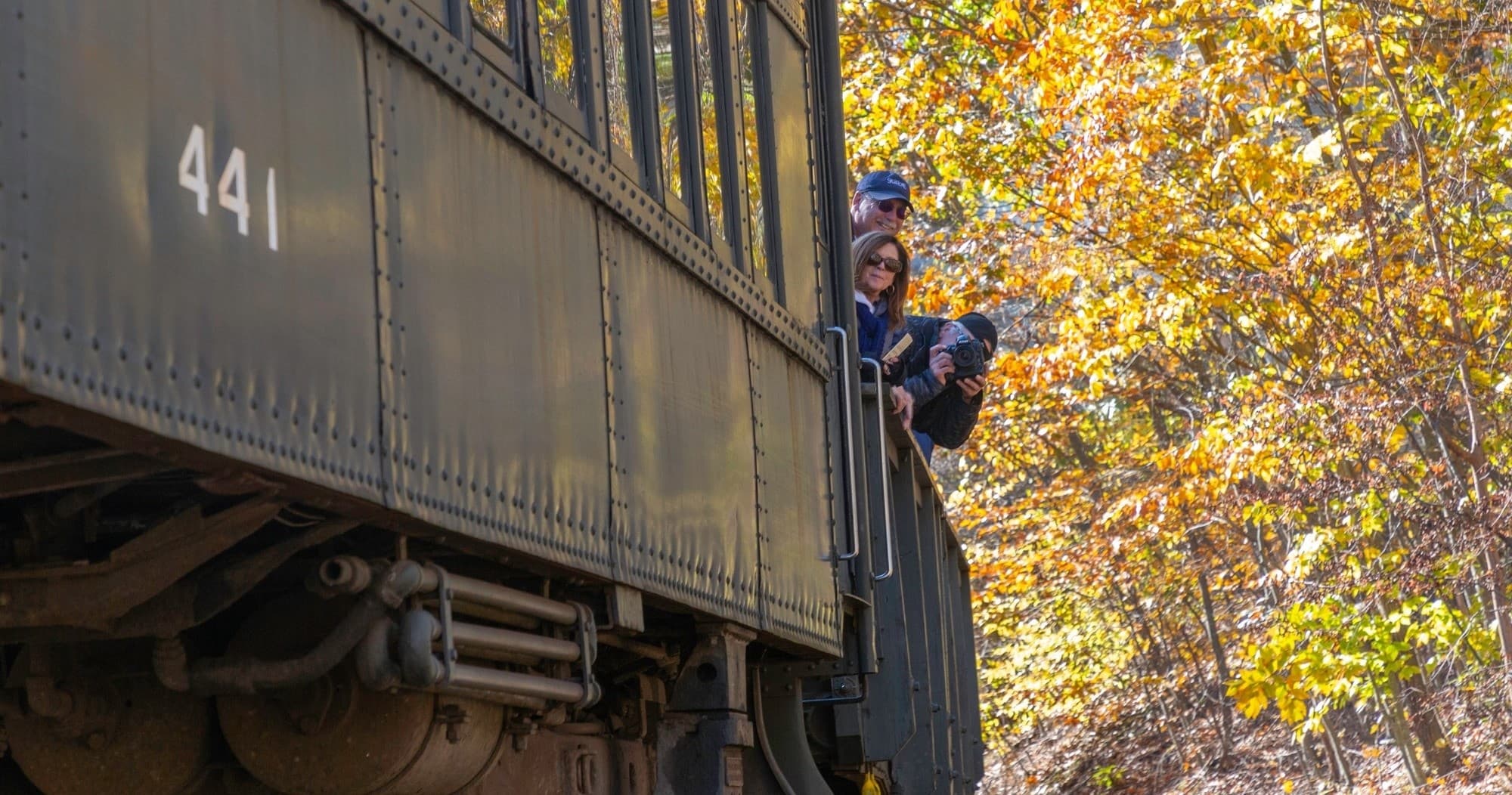 Passenger scenic train ride through autumn woods in Ulster County