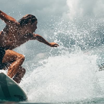 Surfing big wave in Azores, dynamic board ride and splash