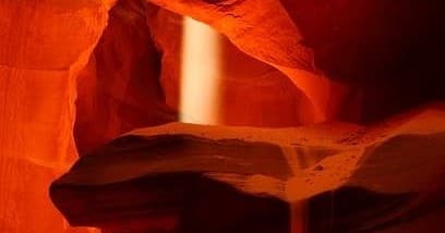 Sunbeam inside Antelope slot canyon with sandy ledge