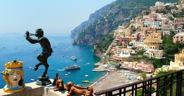 Scenic Positano seaside balcony with coastal statue and bay view
