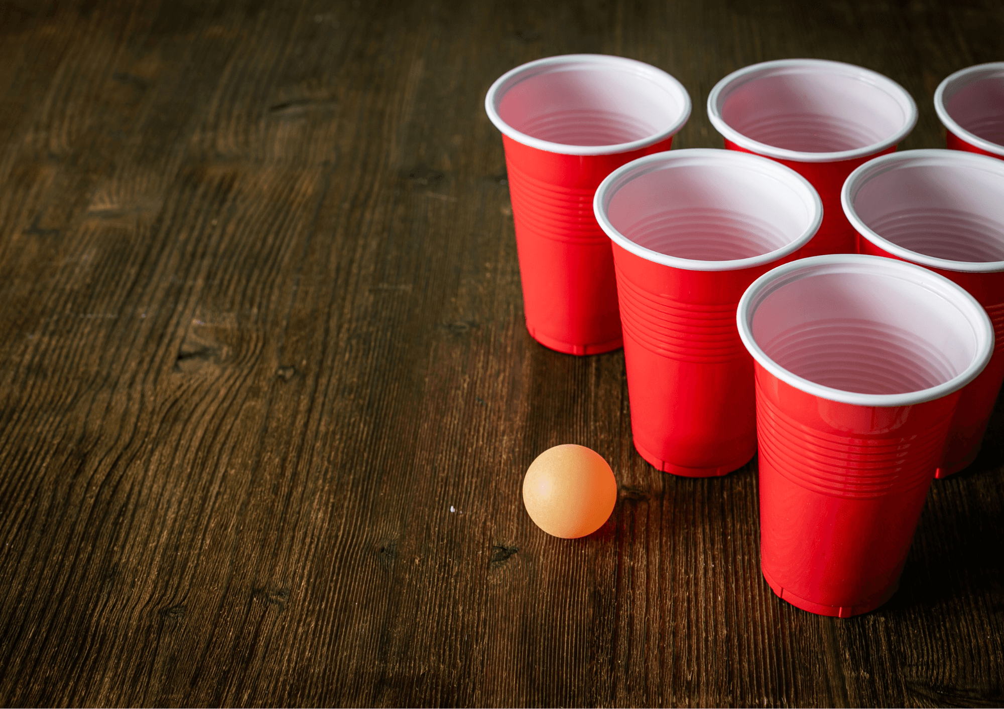 Red solo cups and ping pong ball on wooden table party game
