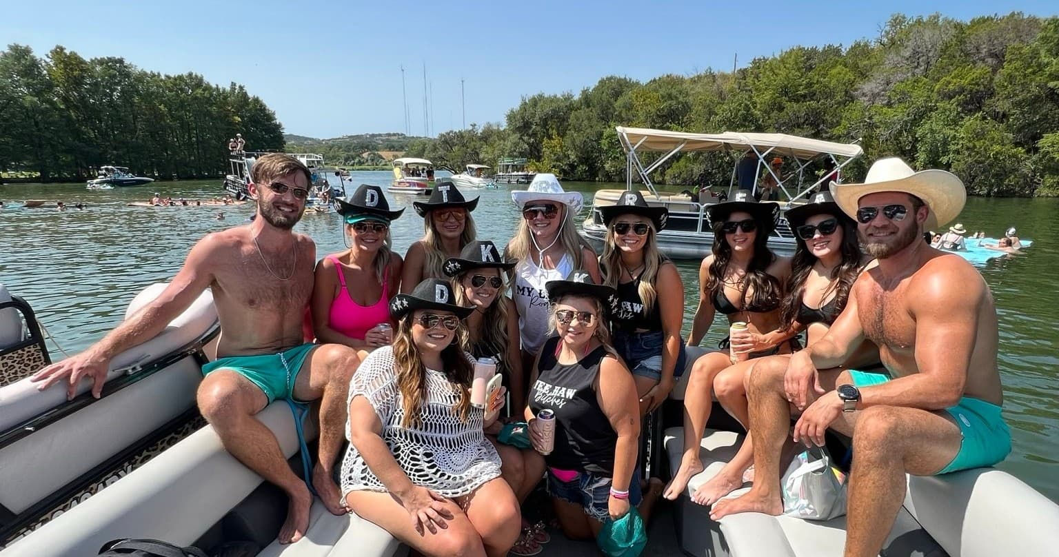 Large crew enjoying a panoramic pontoon cruise on clear lake