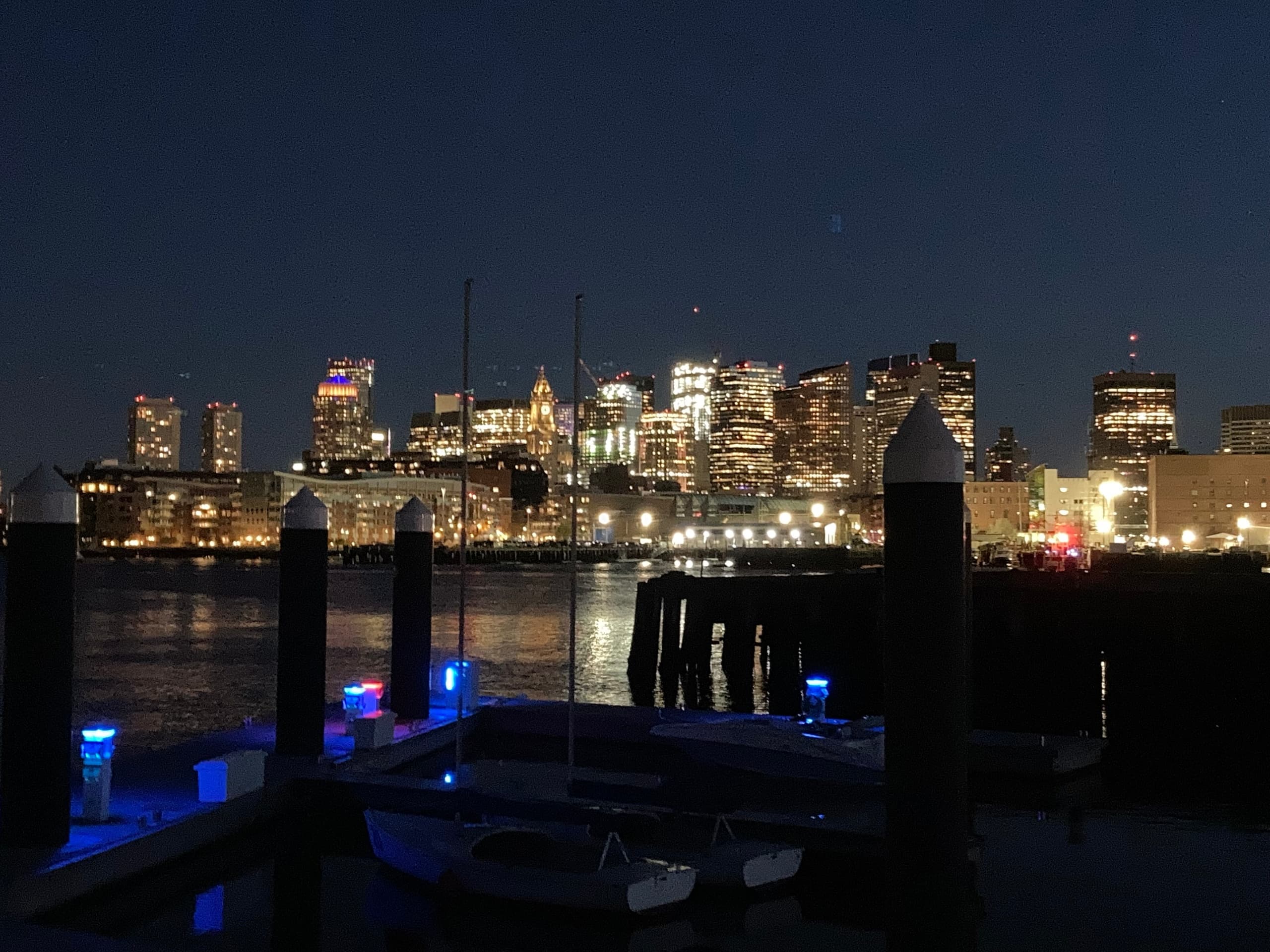 Night harbor skyline reflected over docks for evening boating