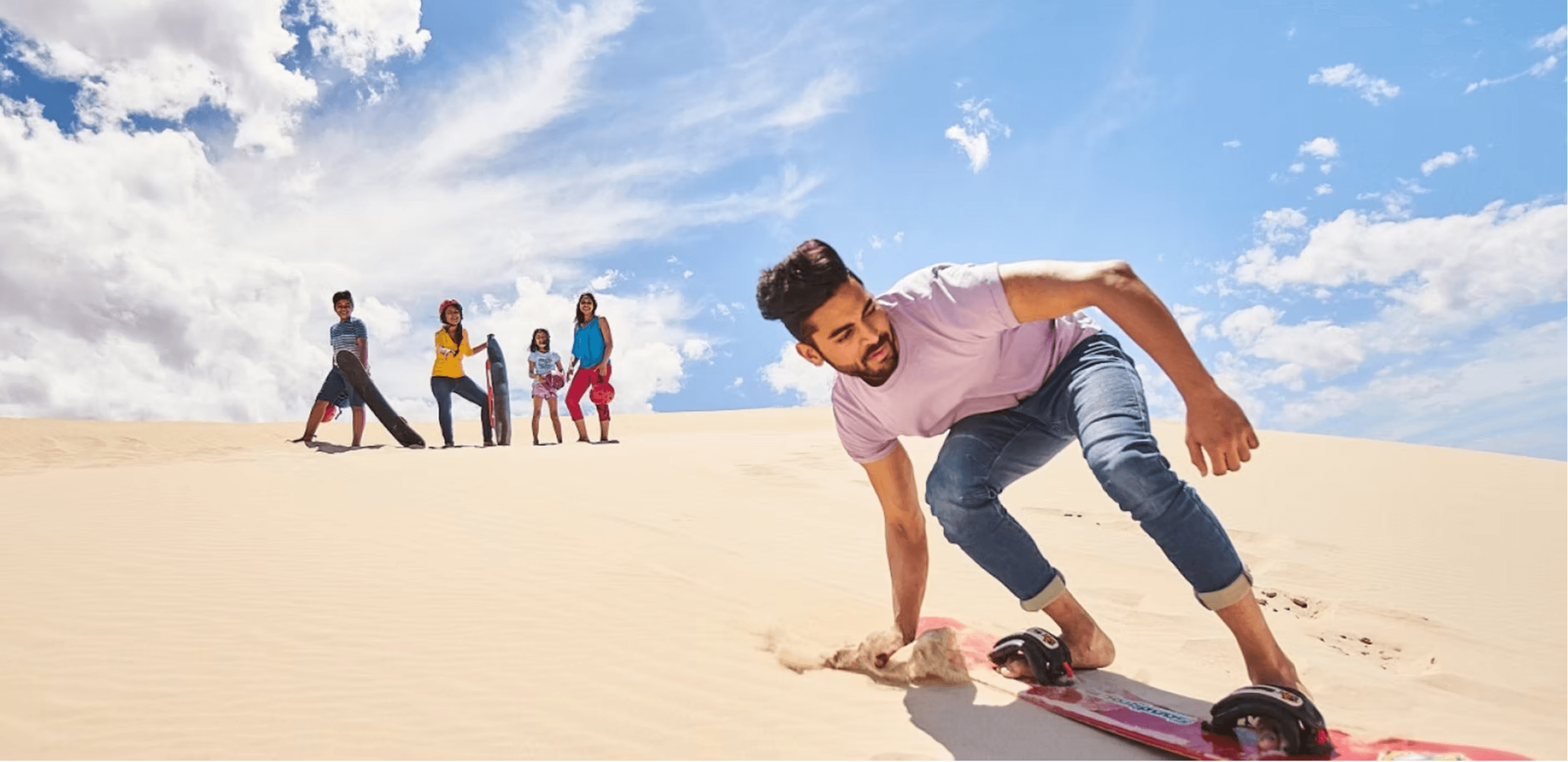 Sandboarder carving dunes on Kangaroo Island beach adventure