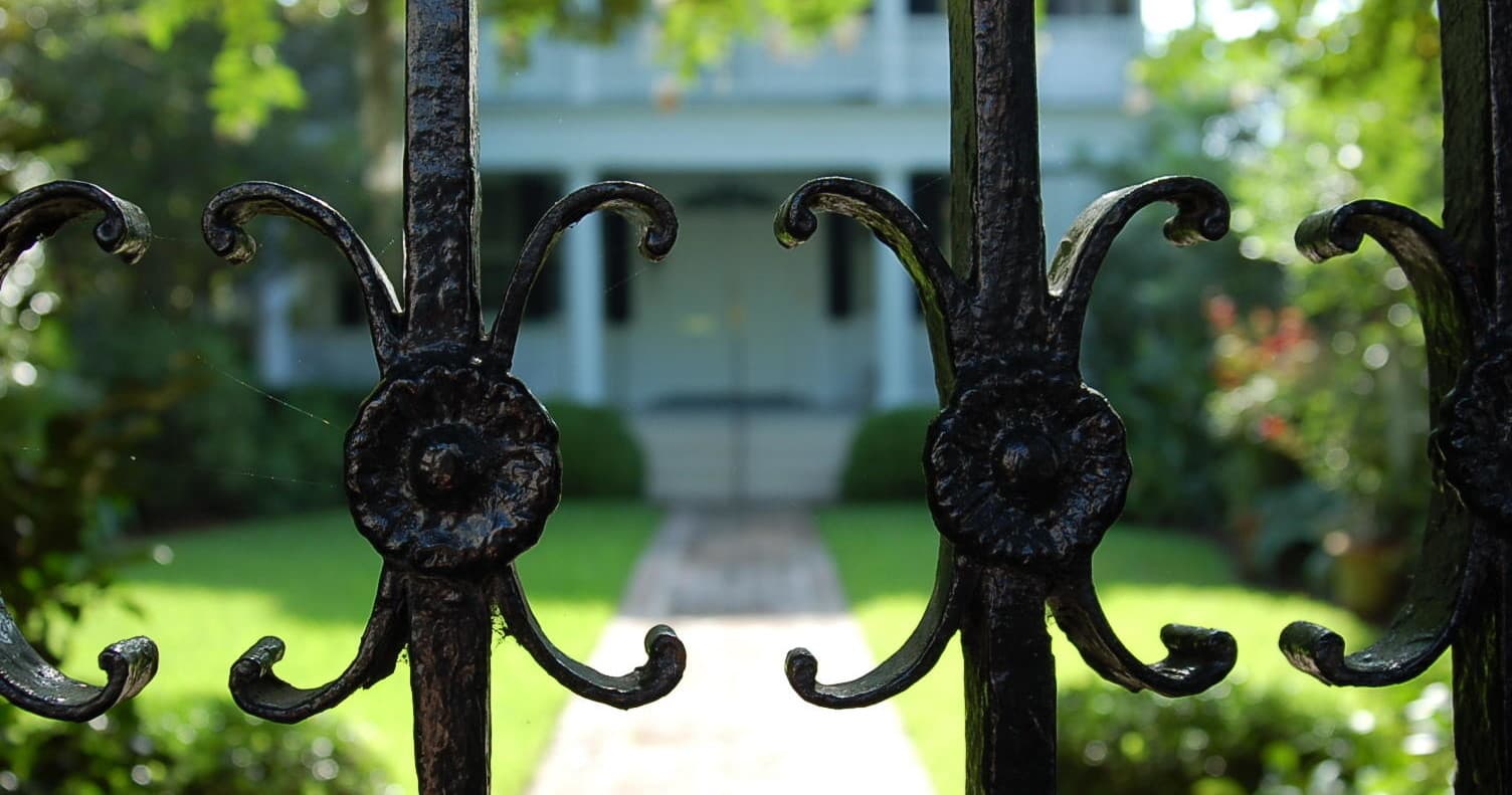 Ornate iron gate framing historic Charleston garden entrance