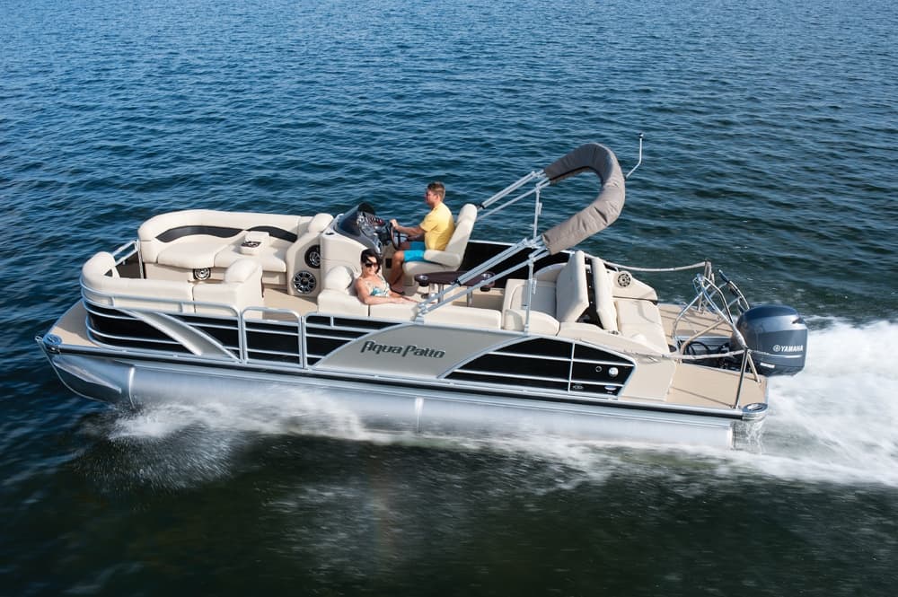 Pontoon boat cruising on open coastal waters with passengers