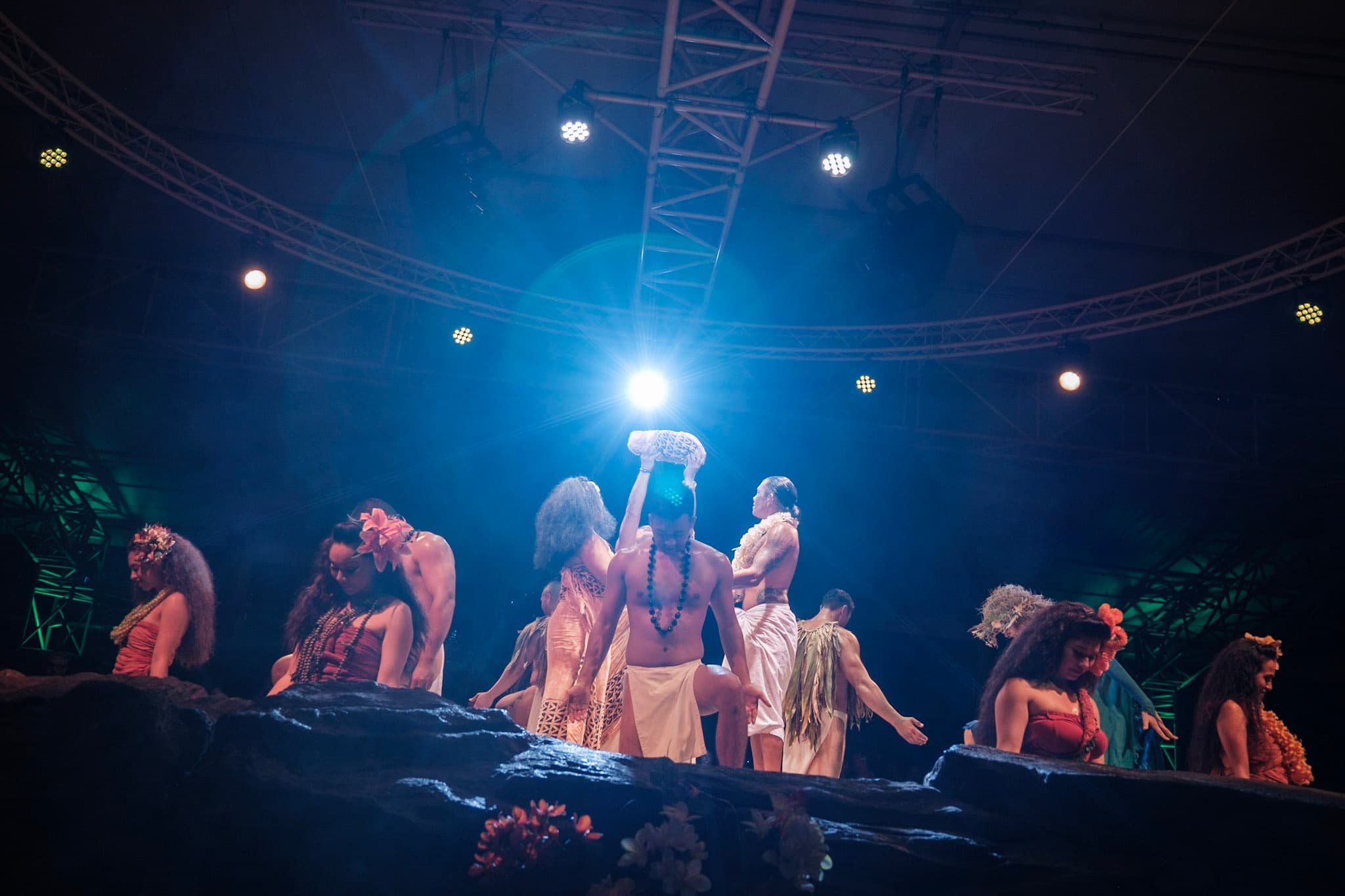Night luau performance under stage lights on outdoor stage
