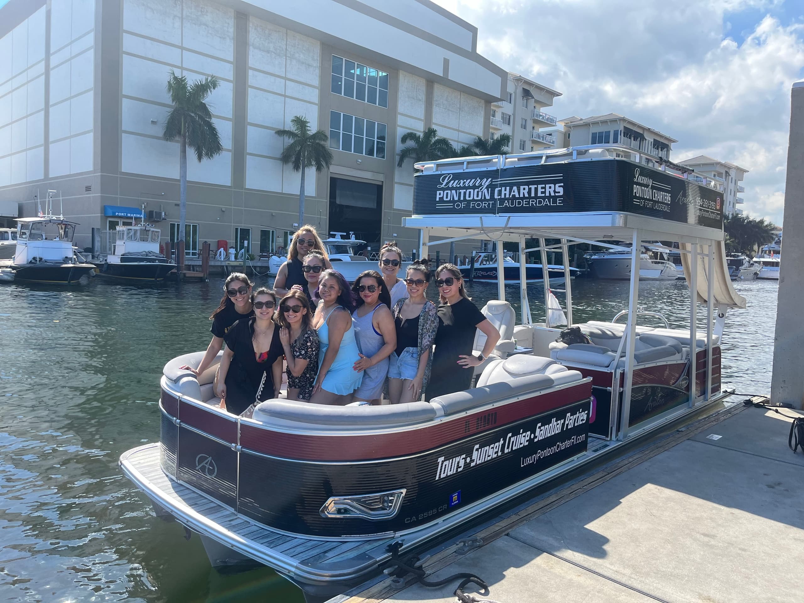 Group aboard pontoon charter docked in Fort Lauderdale marina