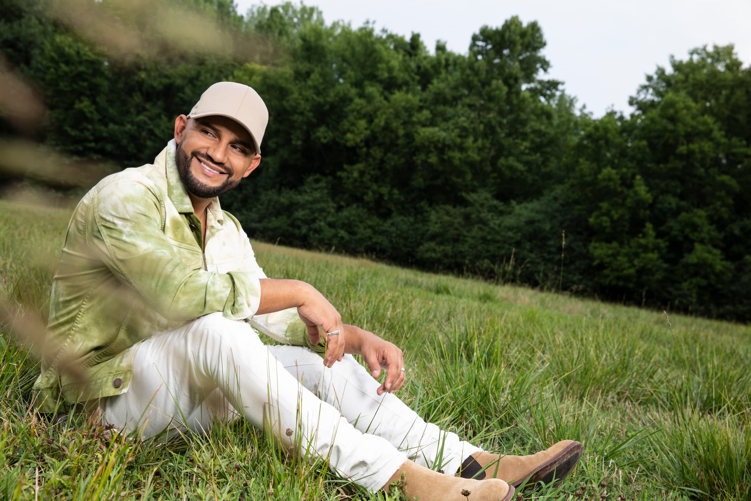 Musician relaxing in grassy field at Maui outdoor retreat