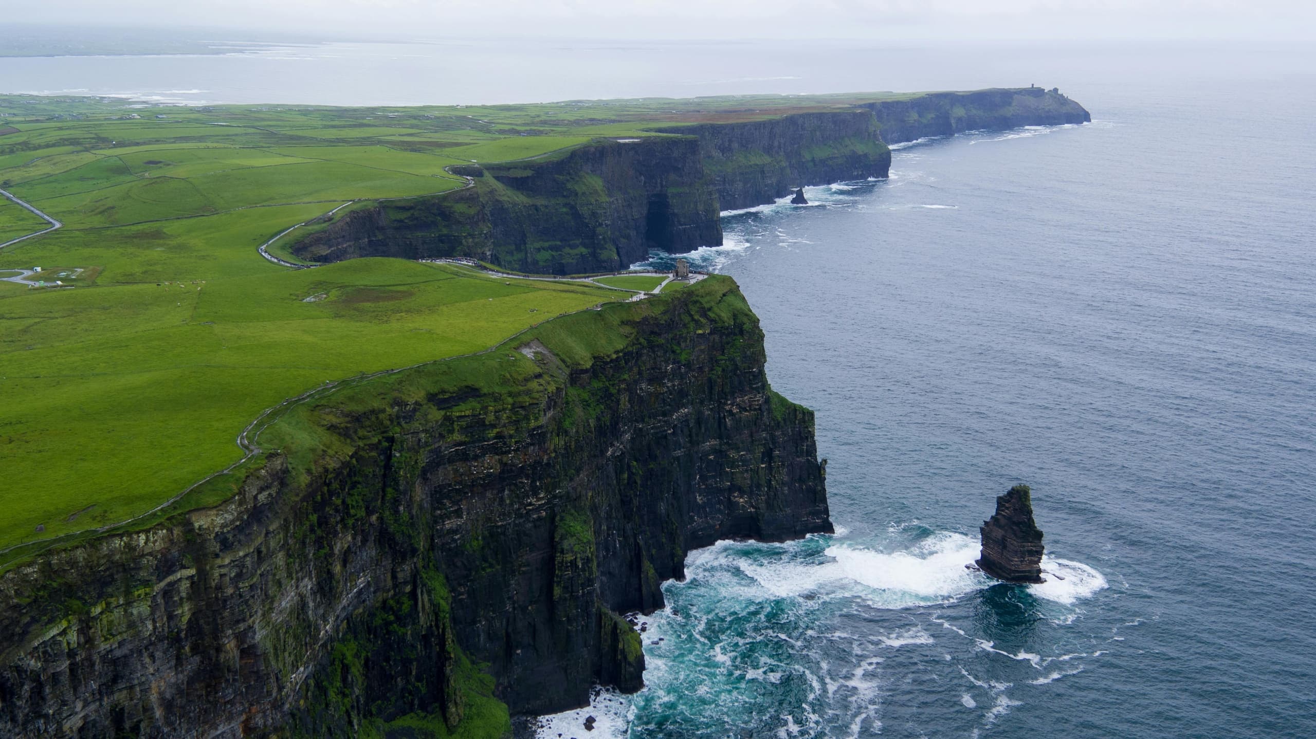 Scenic seaside cliffs and sea stack along rugged Irish coastline