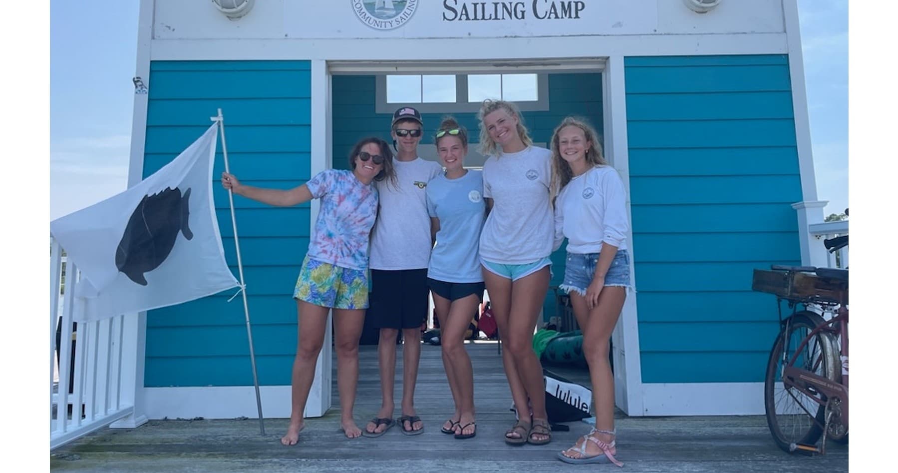 Sailing instructors posing outside Cape Charles sailing camp office