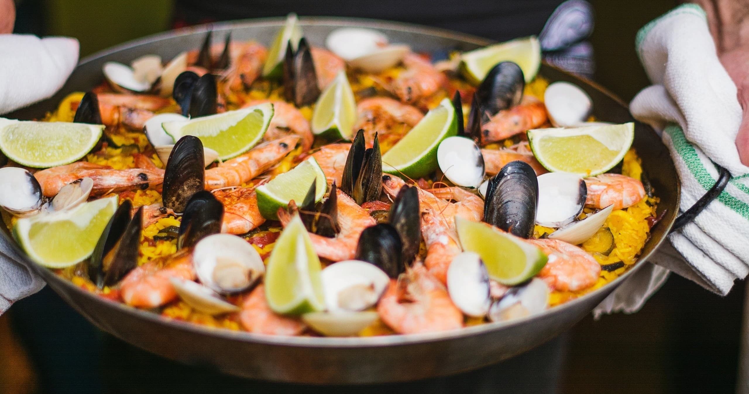 Seafood paella in large pan at seaside festival or outdoor feast