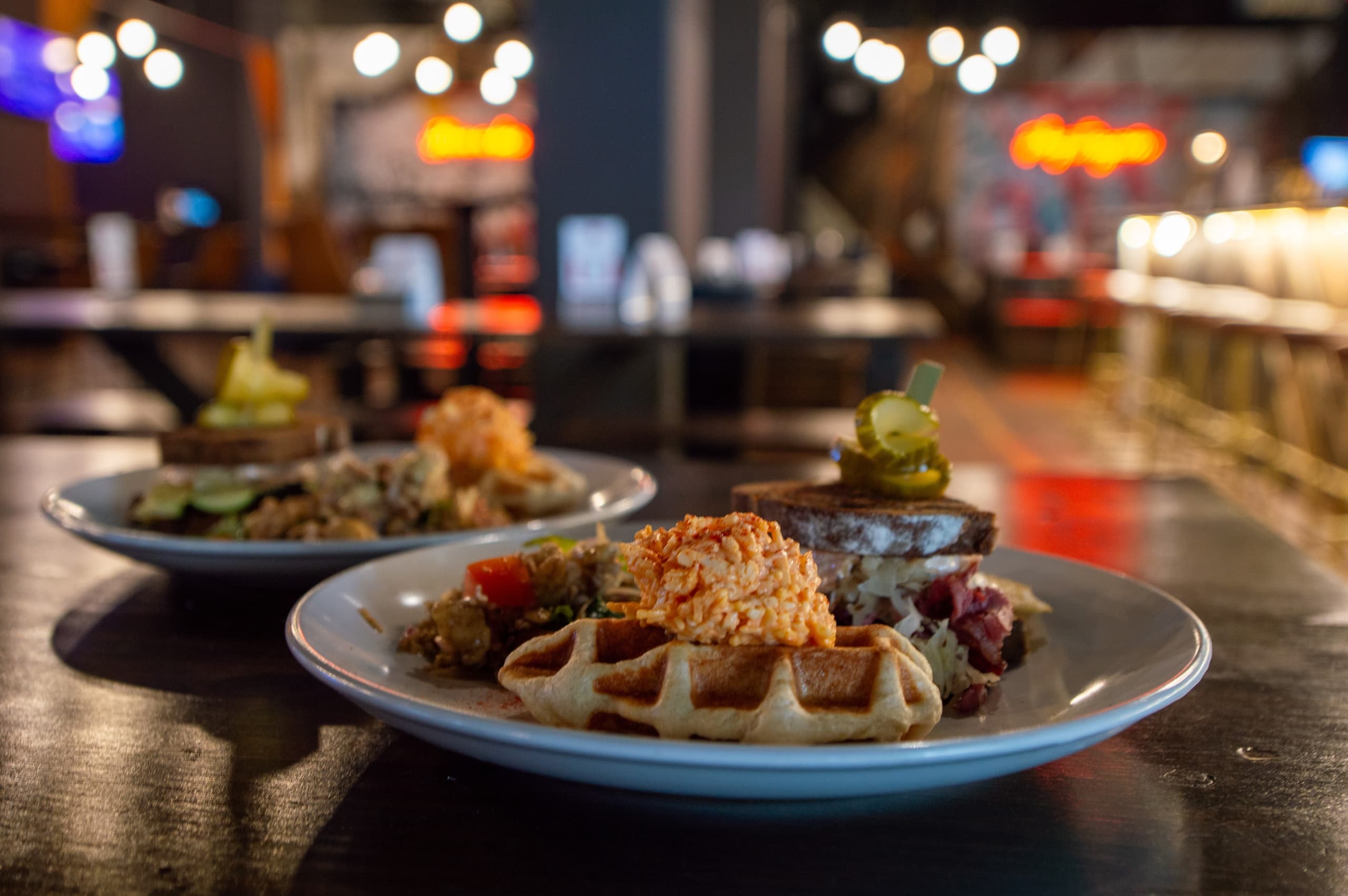Gourmet plate with waffles and toppings on restaurant counter
