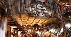Visitors sampling moonshine at rustic Ole Smoky Moonshine Holler distillery