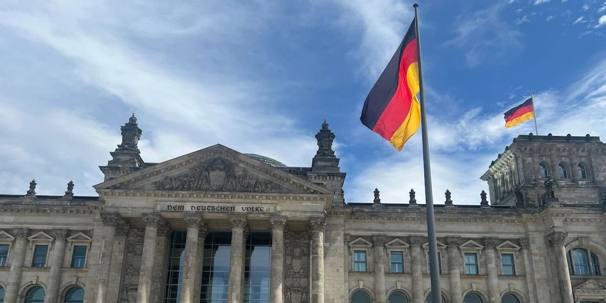 Reichstag building facade with German flag at historic Berlin parliament