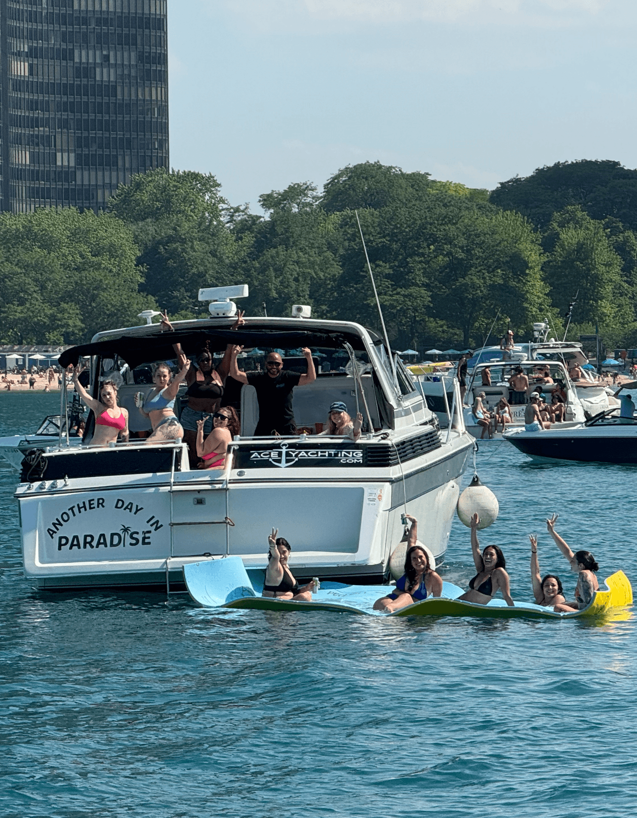 Crowded party boat with swimmers on Lake Michigan near shore