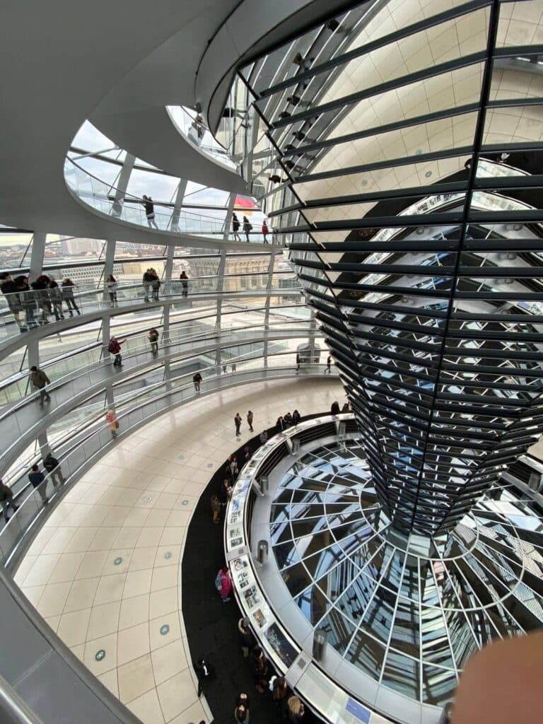 Visitors touring Berlin Reichstag glass dome interior spiral