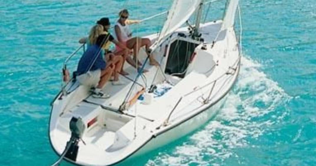 Leisure sailing trip on white sailboat across turquoise ocean