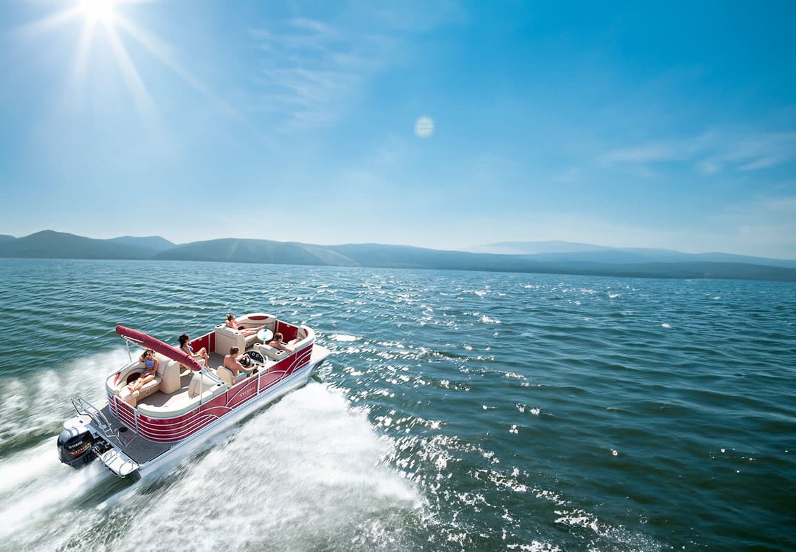 Speedboat cutting through blue lake water on sunny summer day