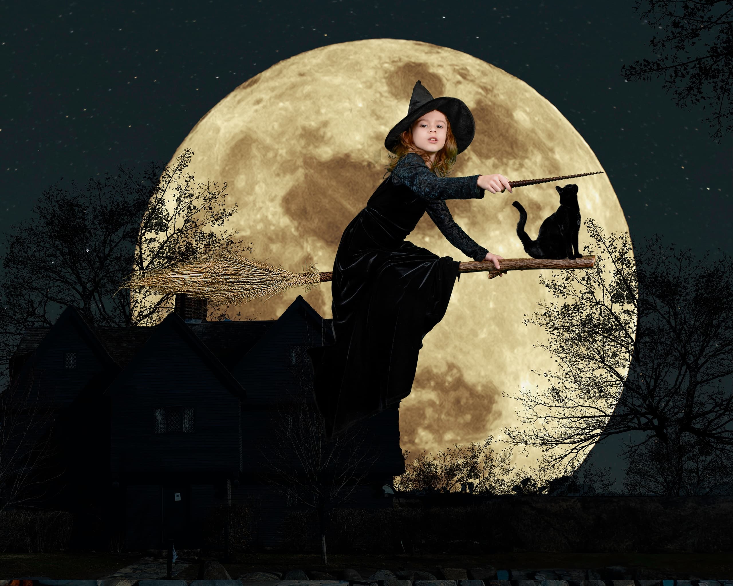 Witch silhouette flying on broom before full moon over countryside