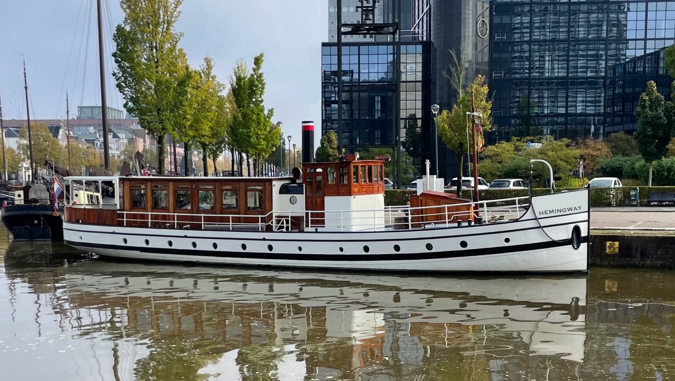 Classic sightseeing boat moored on Berlin riverfront, calm harbor